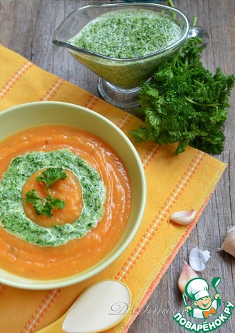 Autumn pumpkin-tomato cream soup with green sauce